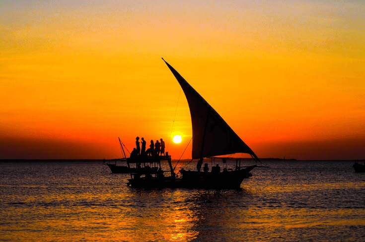 Traditional dhow sailing at sunset in Zanzibar for the 5 Days Zanzibar flying package